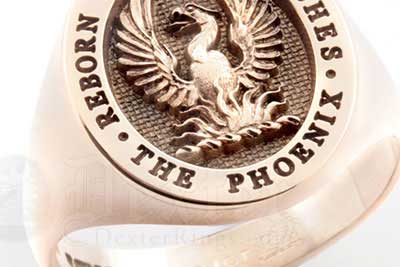 Phoenix rising from the flames - an elevated crest design on a red gold ring