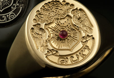 Engraved Around This Solitaire Ruby Complimenting this Client Imagined Balinese 'Family Arms' Style Ring