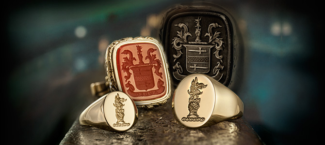 two gold signet rings engraved with crests and fob engraved with a coat of arms